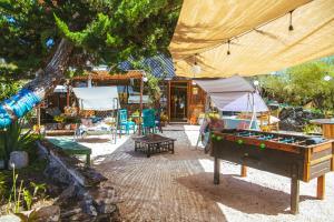 a garden with a pool table and a tent at Aldea Bahiguana in Bahia Inglesa