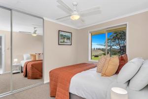 a bedroom with a bed and a large mirror at Vinea Vista - Hillside Homestead amid Rural Beauty in Lenswood
