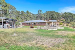 a house with a large yard in front of it at Vinea Vista - Hillside Homestead amid Rural Beauty in Lenswood