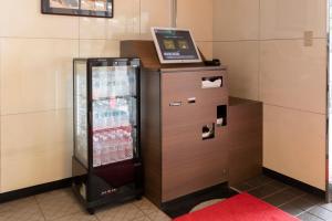 a refrigerator with a laptop on top of it at Hotel Cerezo in Tokyo