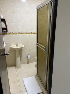 a bathroom with a shower and a sink at Apartamentos KARS in Ríohacha +8 photos