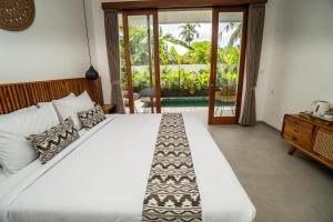 Postel nebo postele na pokoji v ubytování Kemari Ubud + 37 fotografií