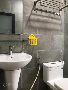 a bathroom with a sink and a toilet at Gp Apartment View Beach in Da Nang