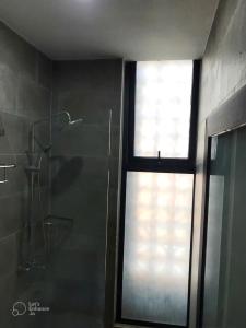 a window in a bathroom with a shower and a shower at Gp Apartment View Beach in Da Nang +6 photos