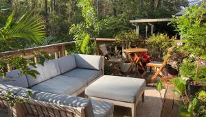 a couch and a chair in a garden at Masters 2026 in your backyard in Augusta