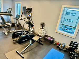 a room with a gym with exercise equipment and a window at The Sugar Suite - Renovated with a View! Ski IN-OUT! Heated POOL, Hot tub, sauna, gym, AC, EV in Sugar Mountain