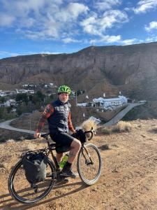 a man is riding a bike on a hill at Bike Cueva Gorafe in Gorafe
