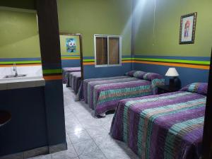 Postel nebo postele na pokoji v ubytování Hotel La Escalinata