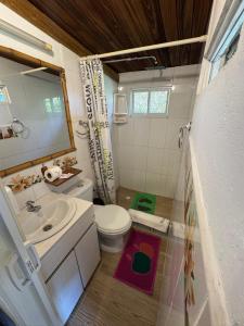 a small bathroom with a toilet and a sink at Green Bamboo Lodge in San Francisco de Borja