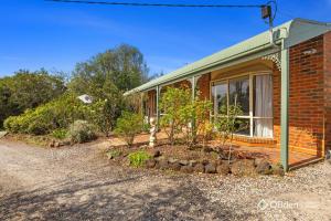 a brick house with a window and some bushes at Family and Spa Oasis in Cowes