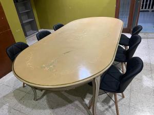 a table with chairs around it in a room at H&S RIS Homestay in Kuala Terengganu
