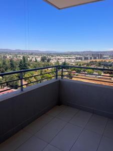 a balcony with a view of a city at Depto equipado - WiFi rápido - 1 min de UCM - piscina rooftop in Talca