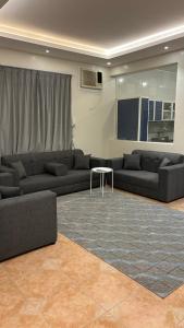 a living room with two couches and a table at مجمع الخليج للفلل السكنية in Abha