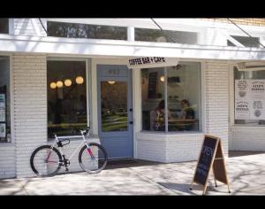 a bike parked in front of a coffee shop at Downtown Zen 2-Bedrooms Private Bungalow in St Petersburg +11 photos