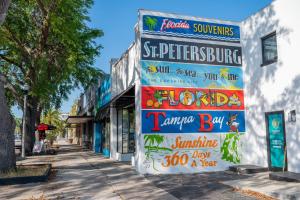 a building with signs on it on a street at Downtown Zen 2-Bedrooms Private Bungalow in St Petersburg