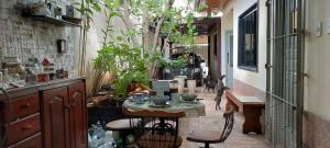 a hallway with a table and chairs and plants at Suit Confort in Porto Velho