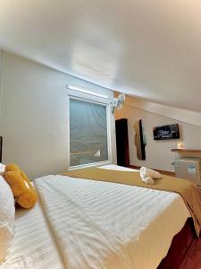 Postel nebo postele na pokoji v ubytování Quang Minh Dalat Hotel