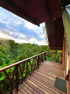 a wooden balcony with a view of the forest at The Sunset Los Naranjos in Santa Marta +14 photos