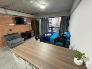 a living room with a couch and a table at Medellín Apartment Loft in Medellín