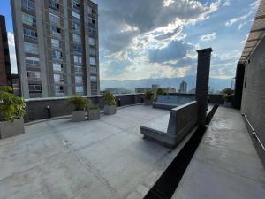 a balcony with a bench on top of a building at Medellín Apartment Loft in Medellín