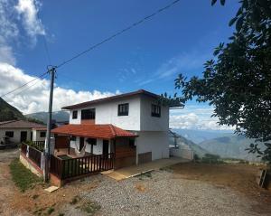 a house on top of a hill with a view at El Nido de Fenix in Aratoca +11 photos