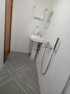 a bathroom with a sink and a shower at Lemon Tree Homestay Prime Location in Darjeeling