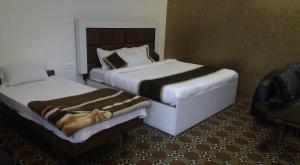 Postel nebo postele na pokoji v ubytování Celestial Resorts