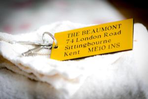 a small yellow tag sitting on a piece of paper at The Beaumont in Sittingbourne +17 photos