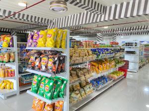 a grocery store aisle with a lot of food at Perc Hotel in Pinamungahan