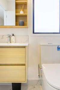 a bathroom with a sink and a toilet at City-Fringe Gem Chic Studio in Prime Location in Christchurch +9 photos