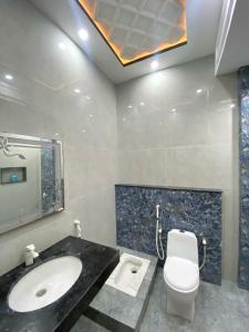 a bathroom with a sink and a toilet at Gulistan Inn in Faisalabad