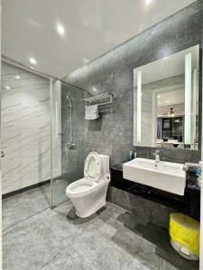 a bathroom with a toilet and a sink and a shower at Altara Residences Apartment - Căn Góc View Biển in Quy Nhon
