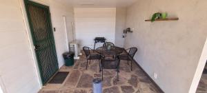 a dining room with a table and chairs in a room at Windana Cottages in Hawker