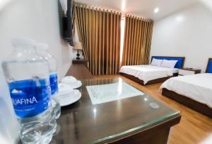 a bottle of water on a table in a hotel room at Cat Ba Charm Island Hotel in Cat Ba +49 photos