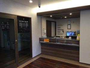 a restaurant with a cash register and a counter at BEPPU ROJIURA stay&sauna in Beppu