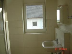 a bathroom with a sink and a window at Ferien-Appartement in Sasbach am Kaiserstuhl in Sasbach am Kaiserstuhl