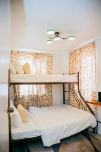 two bunk beds in a room with a window at Love, Lourdes Villa in Imus