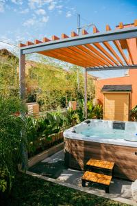 a hot tub in a garden with a pergola at Love, Lourdes Villa in Imus