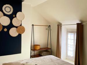 a bedroom with hats hanging on the wall at Gîte tout confort 2 ch, jardin, proche Blois & Chambord - FR-1-491-463 in Saint-Claude-de-Diray