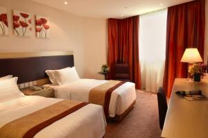Voodi või voodid majutusasutuse Grandview Hotel Macau toas
