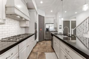 a white kitchen with a stove and a sink at Best Day Ever townhouse in Washington