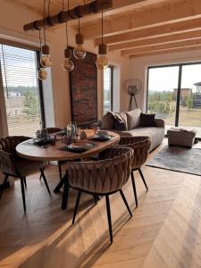a living room with a table and a couch at Clonowo 2 in Borsk