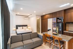 a living room with a couch and a bed at Alyxia 1 Bedroom Apartment in Central Seminyak in Seminyak