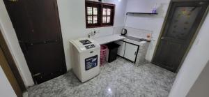 a small bathroom with a sink and a trash can at Villa De Wick's in Kimbulapitiya +3 photos