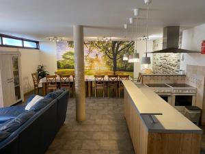 a kitchen and dining room with a couch and a table at La porte des fagnes in Malmedy