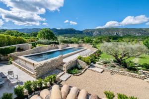 an estate with a swimming pool and a garden at La Bastide de Clara in Oppède