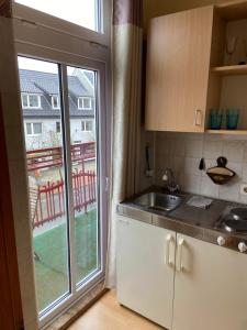a kitchen with a sink and a large window at Kleine Stranddüne in Cuxhaven
