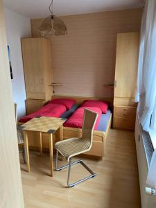 a small bedroom with a bed and a table and chair at Kleine Stranddüne in Cuxhaven