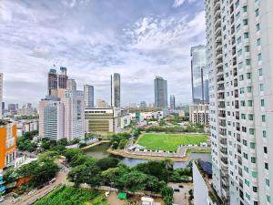 a view of a city with a river and buildings at Strategic 3BR Thamrin Residence Near Pl & GI by 2ndHome in Jakarta