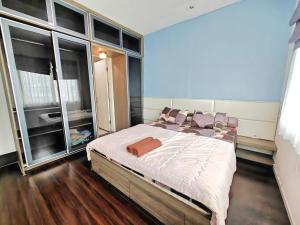 a bedroom with a large bed and large windows at Strategic 3BR Thamrin Residence Near Pl & GI by 2ndHome in Jakarta +32 photos